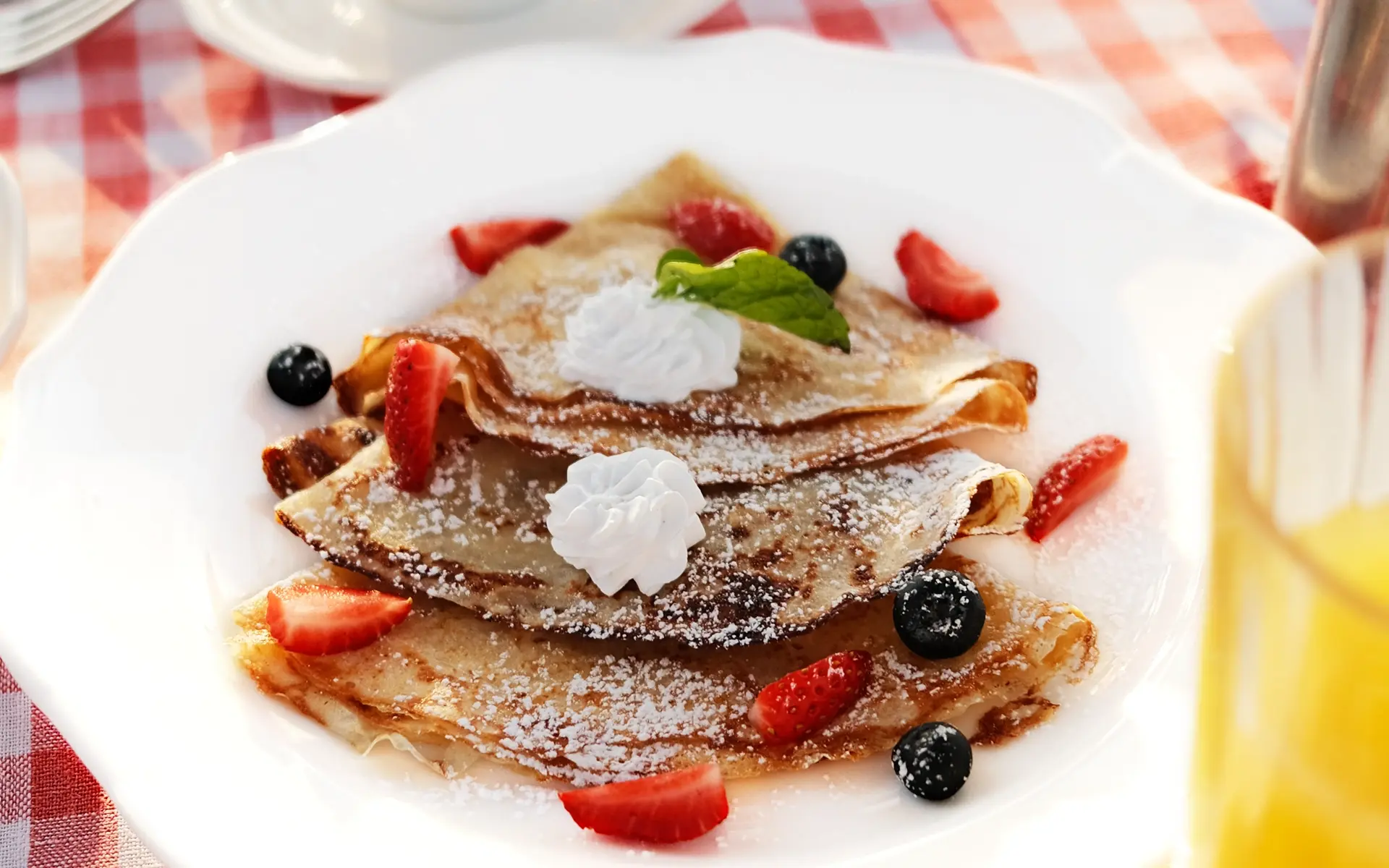 A plate of crepes topped with fresh berries at One Nature Mara River.