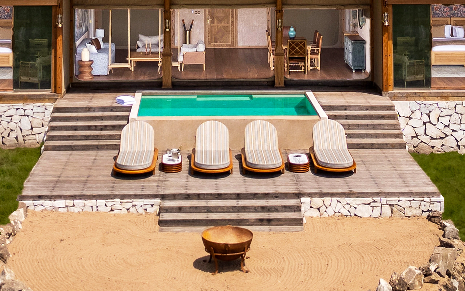 A private deck, with an infinity pool and four sun-beds in the Presidential Villa at One Nature Mara River.