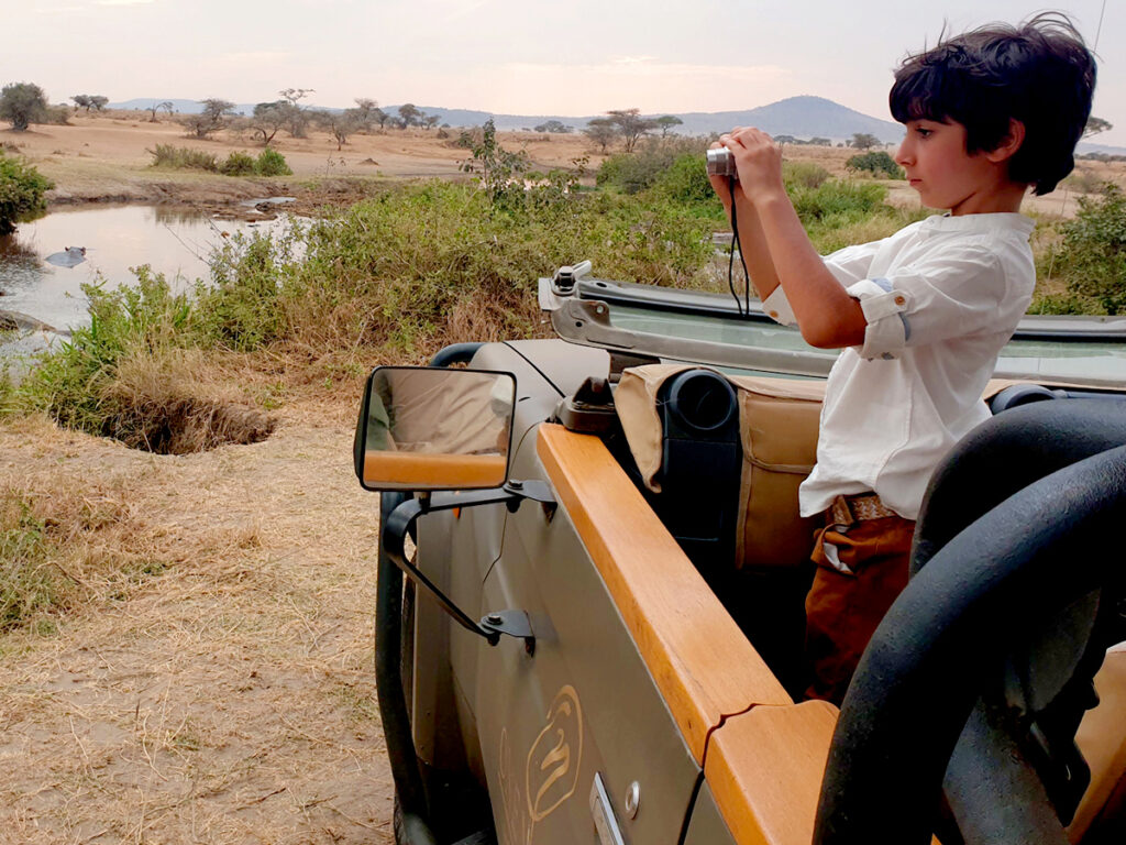 A kid capturing the wildlife on game drives in the Serenegti, Tanzania.