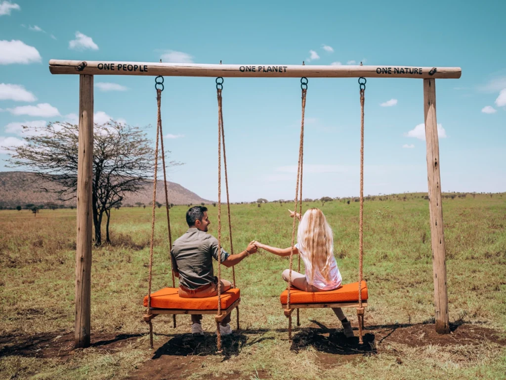 Luxury Safari Lodge Setting: A stunning view of a luxurious Serengeti lodge surrounded by vast, golden plains under a clear blue sky.