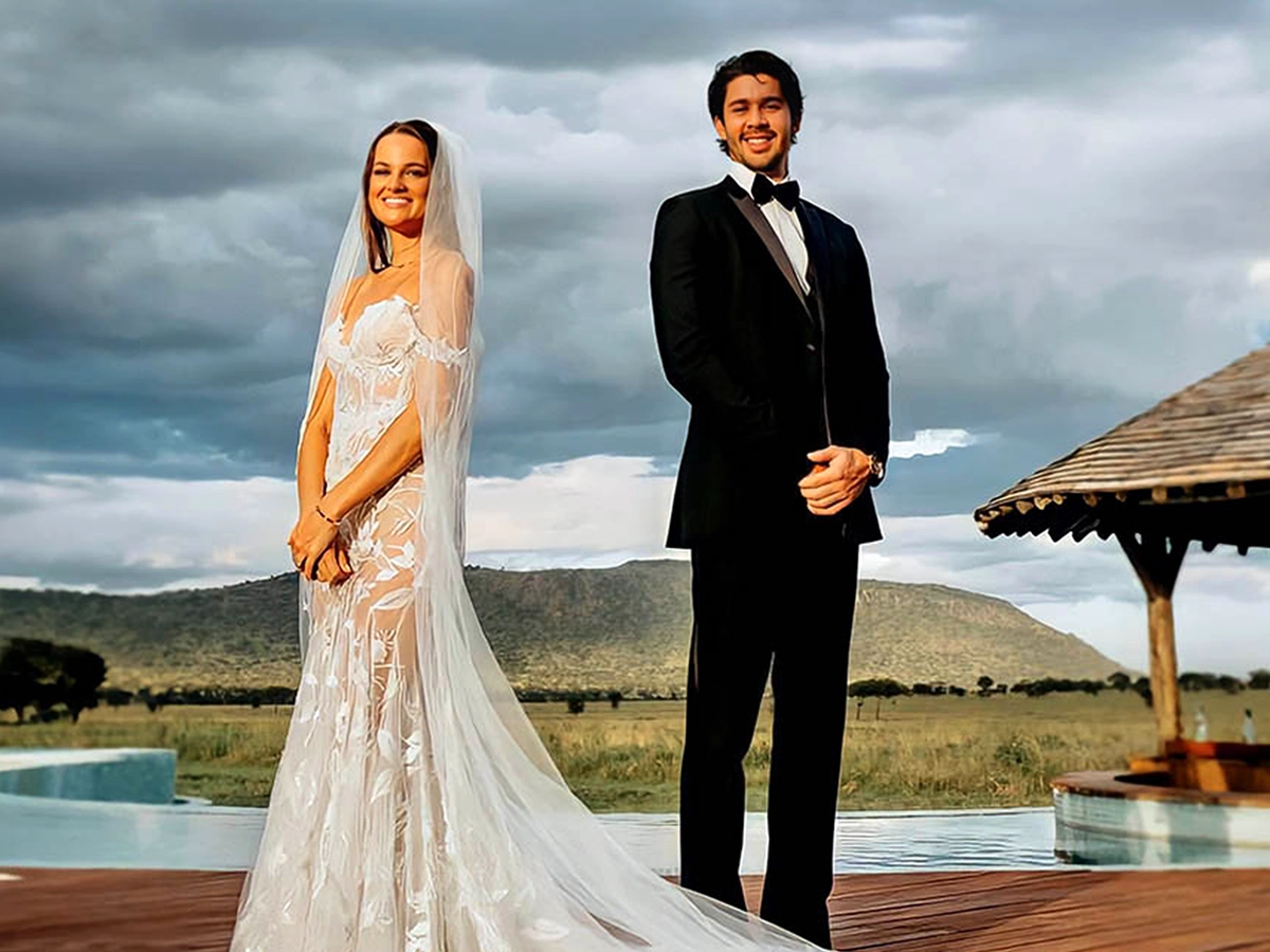 Wedding couple near the One Nature Nyaruswiga pool with stunning Serengeti views.