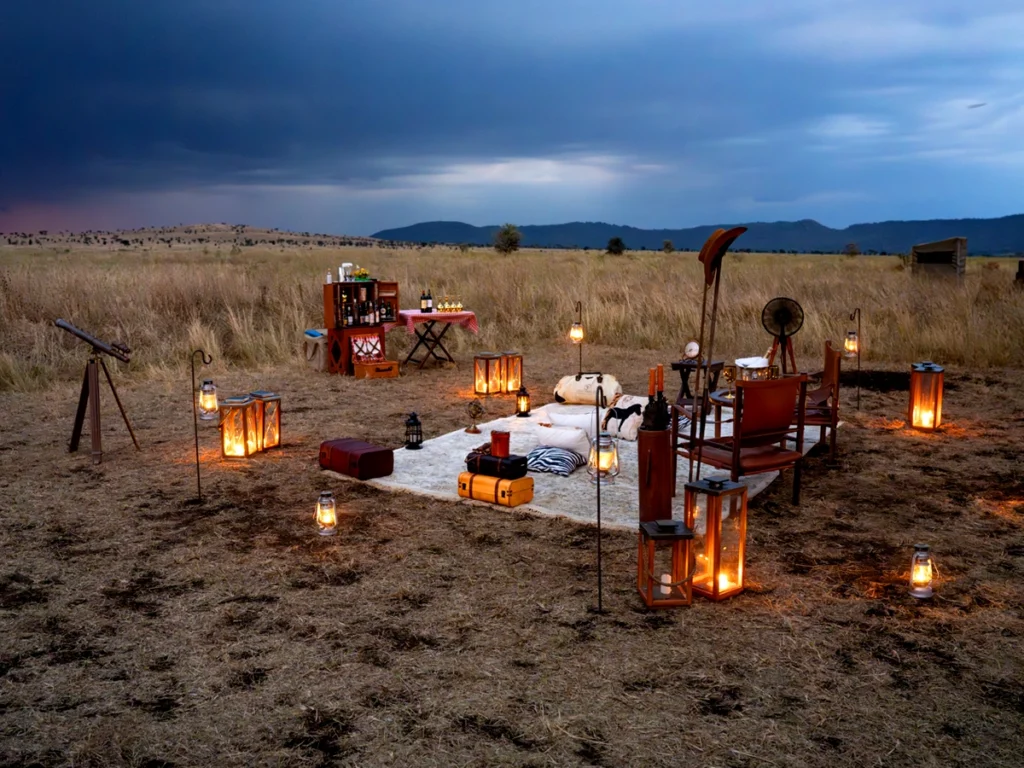 Lanterns and soft lighting warmly illuminate the lodges at One Nature Nyaruswiga